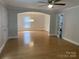 Open-concept living room with hardwood floors, archways, and lots of natural light, perfect for entertaining at 507 Chrysler St, Kannapolis, NC 28083