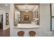 Elegant bar area featuring a marble countertop and seating, perfect for entertaining guests at 5490 Sapwood Ct, Denver, NC 28037