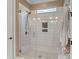 Bathroom featuring a glass shower with white subway tile and decorative accent window at 5490 Sapwood Ct, Denver, NC 28037