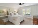 Bright bedroom with a metal frame bed, neutral walls, and white bedding at 5490 Sapwood Ct, Denver, NC 28037