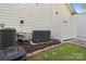 Exterior shot of home featuring an air conditioner, generator, and a manicured lawn with stone border at 5490 Sapwood Ct, Denver, NC 28037