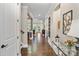 Elegant foyer with hardwood floors, decorative lighting and a view into the living space at 5490 Sapwood Ct, Denver, NC 28037