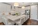 Bright and airy kitchen with a large central island, white cabinets, and modern lighting at 5490 Sapwood Ct, Denver, NC 28037