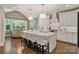 Open-concept kitchen with a large island, white cabinets, and view to the adjacent dining area at 5490 Sapwood Ct, Denver, NC 28037