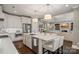 Stylish kitchen featuring a large island with seating and direct access to a cozy living room at 5490 Sapwood Ct, Denver, NC 28037
