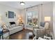 Cozy living room with large window, a neutral sofa, chair, and warm hardwood floors at 5490 Sapwood Ct, Denver, NC 28037
