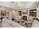 Inviting living room with built-in shelving, a fireplace, and a view of the adjacent bar at 5490 Sapwood Ct, Denver, NC 28037
