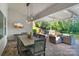 Outdoor patio featuring an elegant dining space, outdoor seating, tv, with a view of the well-manicured backyard at 5490 Sapwood Ct, Denver, NC 28037