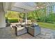 Backyard patio featuring a fire pit table, comfortable seating, and a view of the hot tub and backyard at 5490 Sapwood Ct, Denver, NC 28037