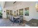 Covered patio with dining and lounge area, providing the perfect space to relax and enjoy the outdoors at 5490 Sapwood Ct, Denver, NC 28037
