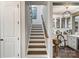 Stairway with wood treads and risers leading up to an open floor plan and view of the kitchen at 5490 Sapwood Ct, Denver, NC 28037