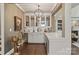 Stylish wet bar featuring white cabinets, a wine fridge, marble countertop and modern lighting at 5490 Sapwood Ct, Denver, NC 28037