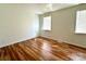 Bedroom featuring hardwood floors and two windows providing natural light at 5812 Hunting Ridge Ln # A, Charlotte, NC 28212