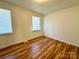 Bright bedroom with hardwood floors and natural light from two windows at 5812 Hunting Ridge Ln # A, Charlotte, NC 28212