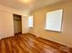 Bedroom with hardwood floors, closet and two bright windows at 5812 Hunting Ridge Ln # A, Charlotte, NC 28212