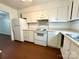 Cozy kitchen featuring white appliances, white cabinetry, and subway tile backsplash at 5812 Hunting Ridge Ln # A, Charlotte, NC 28212