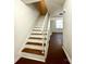 View of the home's staircase with wood and white accents leading to the upper level at 5812 Hunting Ridge Ln # A, Charlotte, NC 28212