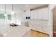 Bright kitchen featuring white cabinets, stainless steel appliances, and a large center island at 604 Banter Ln # 29, Cramerton, NC 28032