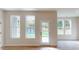 Bright and airy living room featuring large windows and doors and hardwood flooring at 604 Banter Ln # 29, Cramerton, NC 28032