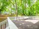 Wooded backyard view from the spacious back deck, perfect for outdoor entertaining at 6100 Hunter Ln, Weddington, NC 28104