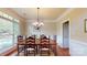 This dining room has hardwood floors, neutral walls, and a wooden dining table with seating for six at 6100 Hunter Ln, Weddington, NC 28104
