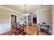 This dining room offers hardwood floors, neutral walls, and a wooden dining table with seating for six at 6100 Hunter Ln, Weddington, NC 28104