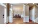 Inviting foyer with hardwood floors, decorative columns, and a clear view into the formal dining room at 6100 Hunter Ln, Weddington, NC 28104
