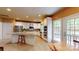 Bright kitchen with white cabinetry, stainless appliances, island, and access to the outside at 6100 Hunter Ln, Weddington, NC 28104