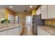 Bright kitchen with a stainless steel fridge and a view into the laundry room at 6100 Hunter Ln, Weddington, NC 28104