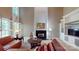 The living room features a fireplace, built-in shelves, and a leather couch surrounding a round coffee table at 6100 Hunter Ln, Weddington, NC 28104