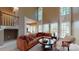 This living room has large windows, neutral walls, and a leather couch surrounding a round coffee table at 6100 Hunter Ln, Weddington, NC 28104