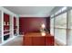 This office features a built-in bookshelf, neutral carpet, and a large desk with window and natural light at 6100 Hunter Ln, Weddington, NC 28104