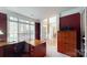 Office with large window, desk, and view of front entry with dining room beyond at 6100 Hunter Ln, Weddington, NC 28104