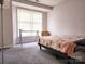 Cozy bedroom with a comfortable bed, desk space, and a well-lit window at 6234 Rosecroft Dr, Charlotte, NC 28215