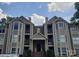 Inviting condo with a covered entrance, private balconies, and neutral siding providing an appealing exterior at 6234 Rosecroft Dr, Charlotte, NC 28215