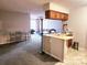 Inviting living room and kitchen combo featuring bar seating and neutral tones at 6234 Rosecroft Dr, Charlotte, NC 28215