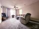 Relaxing living room with plush seating and a large window offering natural light at 6234 Rosecroft Dr, Charlotte, NC 28215