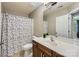 Well-lit bathroom features a modern vanity, neutral tones, and a shower with a colorful polka dot curtain at 639 Lorain Nw Ave, Concord, NC 28027