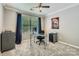 Bright bedroom featuring a ceiling fan, a large window with curtains, and a glass desk at 639 Lorain Nw Ave, Concord, NC 28027