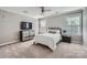 Bedroom features a modern dresser, ceiling fan, and neutral carpeting at 639 Lorain Nw Ave, Concord, NC 28027