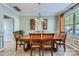 Bright dining room featuring a large table, natural light, and tile flooring at 639 Lorain Nw Ave, Concord, NC 28027