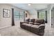 Inviting living room featuring a plush sofa, a window, and neutral color scheme for relaxation at 639 Lorain Nw Ave, Concord, NC 28027