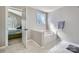 Bright main bathroom featuring a soaking tub and glass block window for natural light at 639 Lorain Nw Ave, Concord, NC 28027
