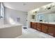 Main bathroom featuring dual sinks, a glass shower, and a soaking tub at 639 Lorain Nw Ave, Concord, NC 28027