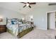 Spacious primary bedroom with a ceiling fan, plush carpet, and a walk-in closet at 639 Lorain Nw Ave, Concord, NC 28027