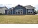 Back exterior of home with a spacious lawn at 705 Hinterland Ln, Matthews, NC 28104