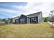 Backyard featuring a well maintained yard with large windows at 705 Hinterland Ln, Matthews, NC 28104