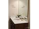 Bathroom featuring a single sink vanity with neutral counters and a framed mirror at 705 Hinterland Ln, Matthews, NC 28104