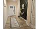 Welcoming entryway features light floors and a decorative accent wall with a gold mirror and table at 705 Hinterland Ln, Matthews, NC 28104