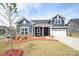 Charming two-story home with manicured lawn and inviting front porch at 705 Hinterland Ln, Matthews, NC 28104